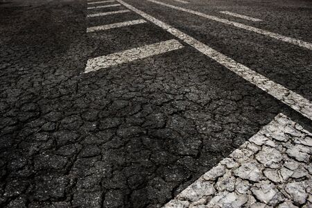 Crack asphalt road on arrow background.の写真素材