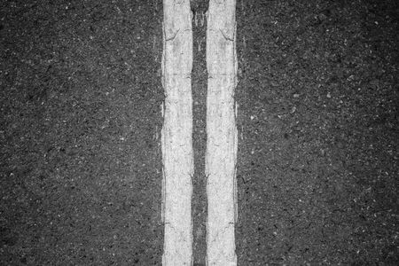 Double whit lines on asphalt background.
