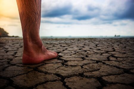 Foot man standing on the dry ground.の写真素材