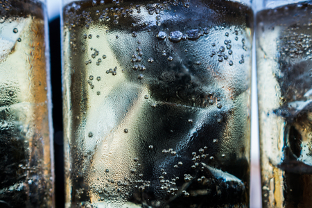 Bubbles in a glass of alcohol.の写真素材