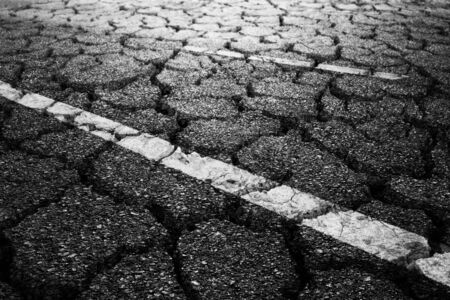 Crack black asphalt road textured background.の写真素材