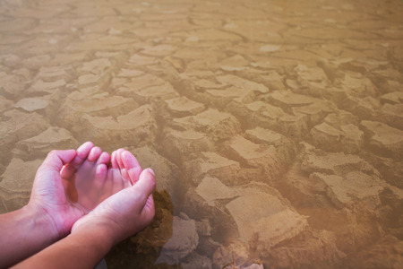 Children hand on ground dry concept drought.の写真素材