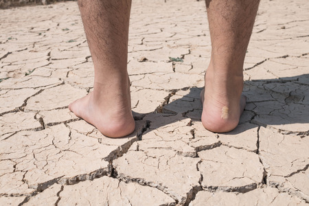 Crack dry ground on foot, drought concept.の写真素材
