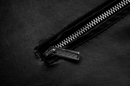 Black zipper and leather texture close up background.の写真素材