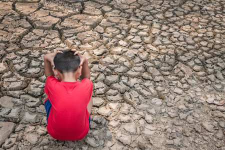 Sad a child on dry ground, Drought concept.の写真素材