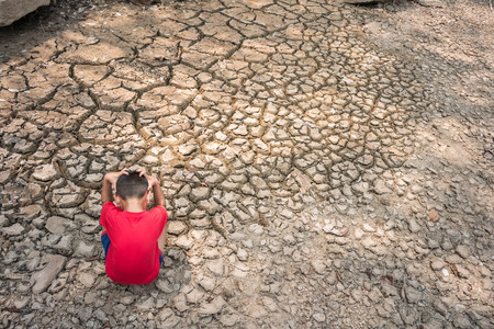 Sad a child on dry ground, Drought concept.の写真素材