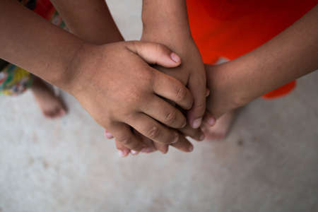 Children hold hand combine forces create friendship concept.の写真素材