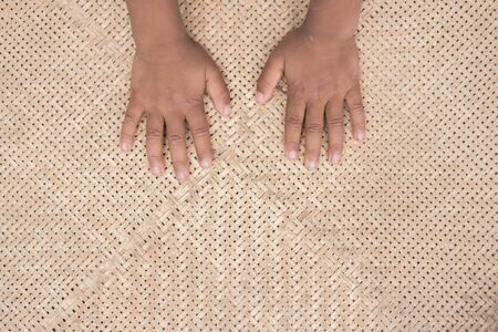 Children hand on basketry bamboo.の写真素材