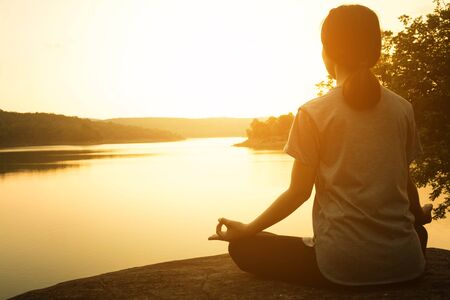 Silhouette young women yoga on nature, Concept yoga.の写真素材