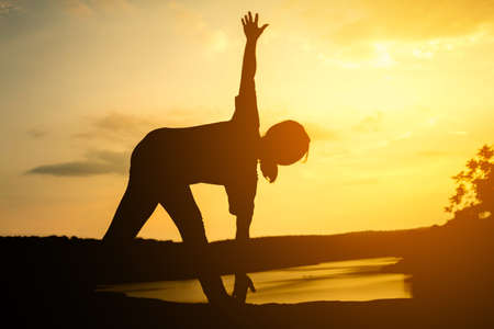 Silhouette young women yoga on nature, Concept yoga.の写真素材