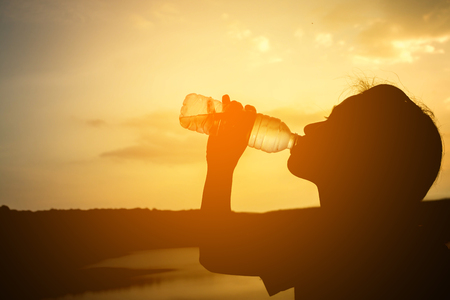 Silhouette women drink water.の写真素材