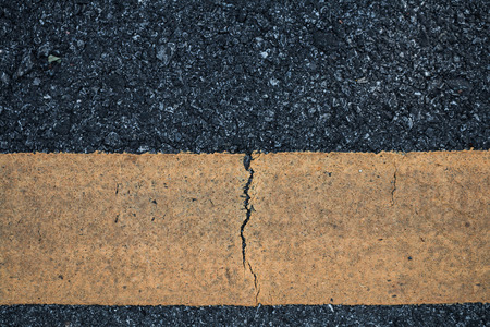 Asphalt road line yellow texture background.の写真素材
