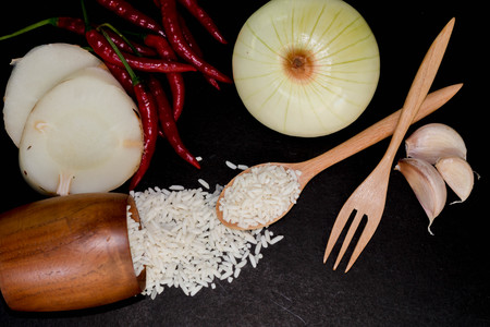Vegetables and rice on a black background.の写真素材