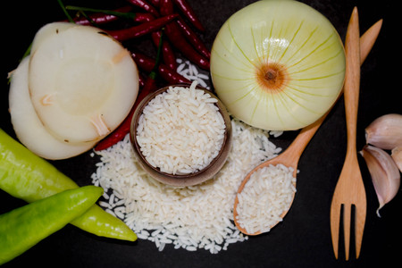 Vegetables and rice on a black background.の写真素材