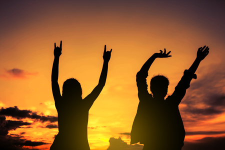 Silhouette girl is dancing happily.の写真素材