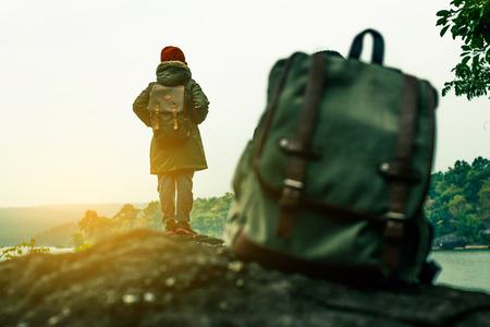 Men with backpack the sit and watch beautiful nature.の写真素材