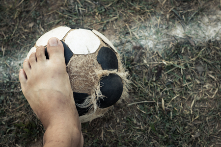 Men play football old, Lack of sports epuipment concept.の写真素材