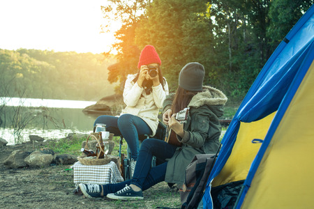 Tourists women and friends camping on the river on holiday.の写真素材
