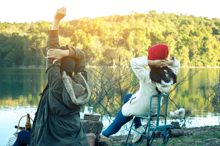 Tourists women and friends camping on the river on holiday.の写真素材