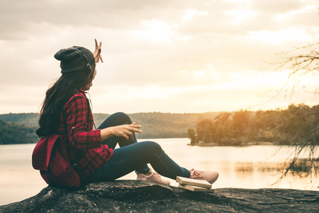 Female travelers listen to beautiful natural music with a quiet scene on holiday.の写真素材