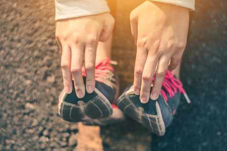 Women runner feet on road in workout wellness concept.の写真素材
