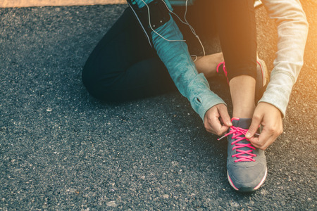 Women tied up the shoe laces prepare to run.の写真素材