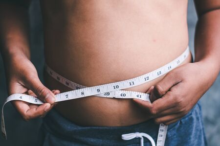 The boys with the waist line want to lose weight.の写真素材