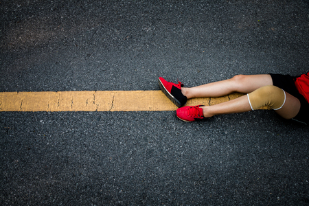 Women runner feet on road in workout wellness concept.の写真素材