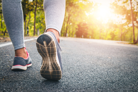 Women runner feet on road in workout wellness concept.の写真素材
