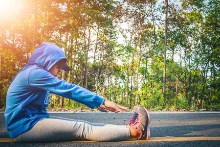 Women runner feet on road in workout wellness concept.の写真素材