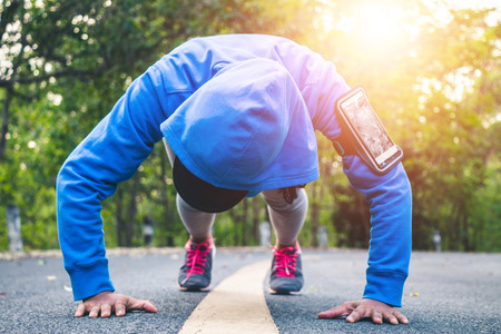 Women runner feet on road in workout wellness concept.の写真素材