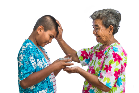 Grandma and grandchildren play in the Songkran festival isolated on white background.の写真素材