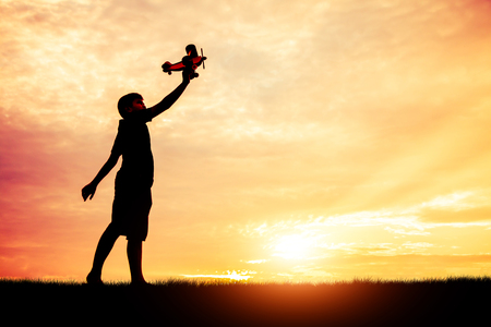 The dream of a child who wants to fly everywhere silhouette.の写真素材