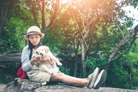 Female tourists and beloved dogs in beautiful nature in a tranquil setting.の写真素材