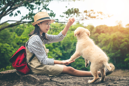 Female tourists and beloved dogs in beautiful nature in a tranquil setting.の写真素材