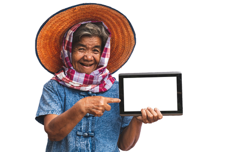 His grandmother used taplet and modern technology to work in agriculture isolated  white background.の写真素材