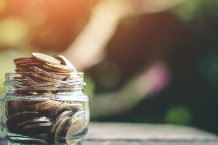 Putting coins in jar with money stack step growth saving money, Concept finance business investmentの写真素材