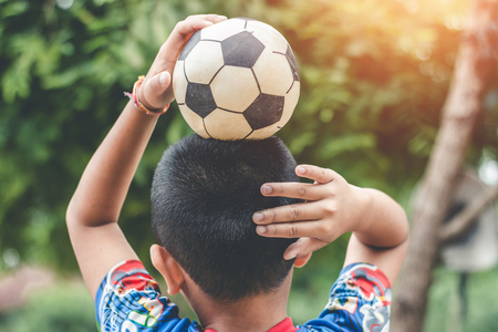 Child play football old, sports epuipment old concept.の写真素材