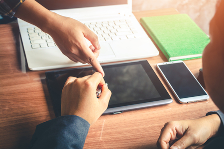 Business people plan their investment using a tablet.の写真素材