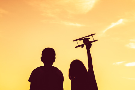 Silhouette the dream of a girl who wants to fly in the sky in nature.の写真素材