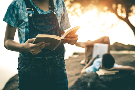 Men and women read books in quiet nature, concept read a books.の写真素材