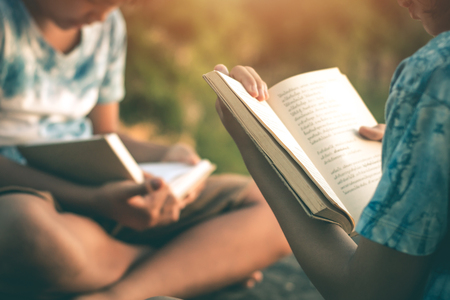 Men and women read books in quiet nature, concept read a books.の写真素材