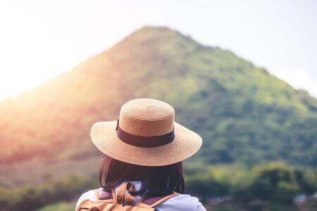 Female tourists in beautiful nature in tranquil scene of rivers and mountains.の写真素材