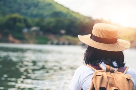 Female tourists in beautiful nature in tranquil scene of rivers and mountains.の写真素材