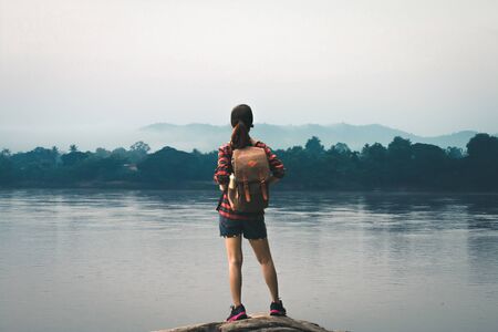 Female tourists in beautiful nature in tranquil scene of rivers and mountains.の写真素材
