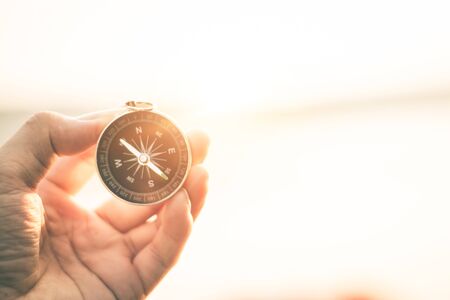 Compass of tourists on mountain at sunset sky.の写真素材