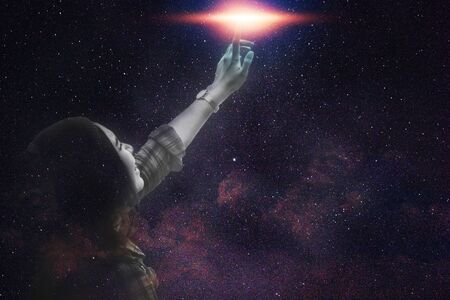 Women listen to music on starry sky.の写真素材