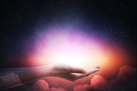 The light of the stars in the sky in the palm.の写真素材