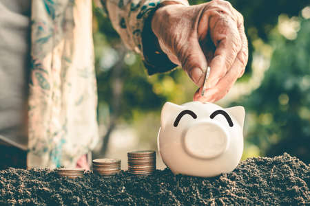 Saving money in pig bank for future use, Concept saving money for the future.の写真素材