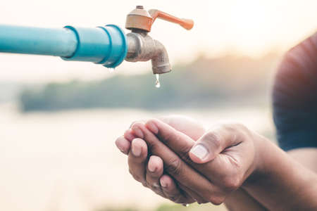 Men hand are waiting to drink water in the water shortage.の写真素材